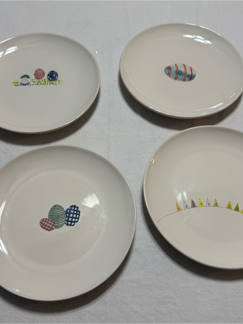 Rae Dunn White Ceramic Accent Plates with Multicolor Egg Motifs